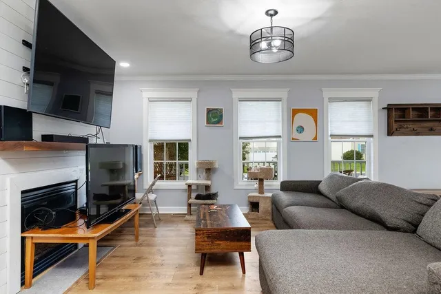 a living room with furniture flat screen tv and a fireplace