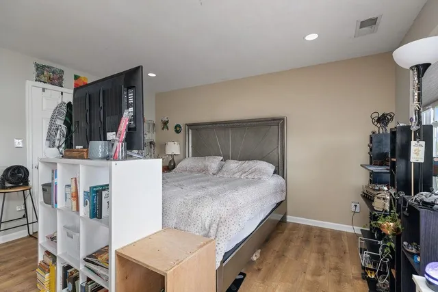 a bed room with a bed and a flat tv screen