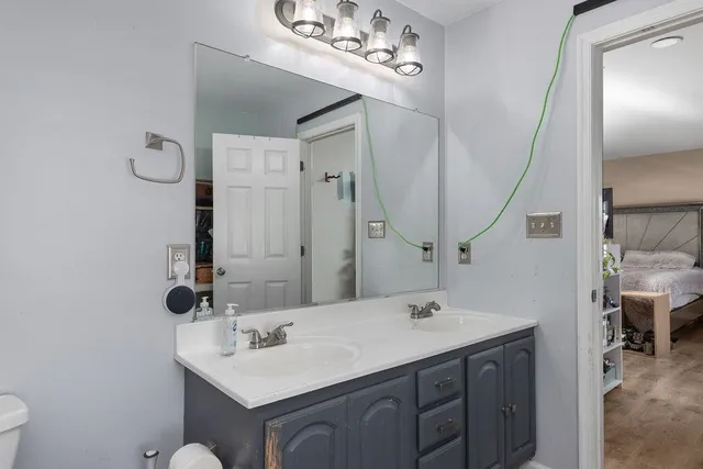 a bathroom with a sink vanity and a mirror