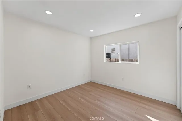 a view of a room with wooden floor and window
