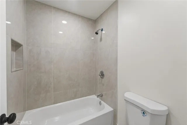 a bathroom with a bathtub and toilet