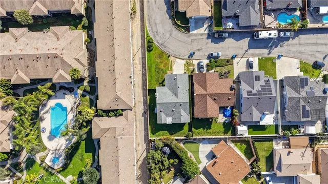an aerial view of residential houses with outdoor space