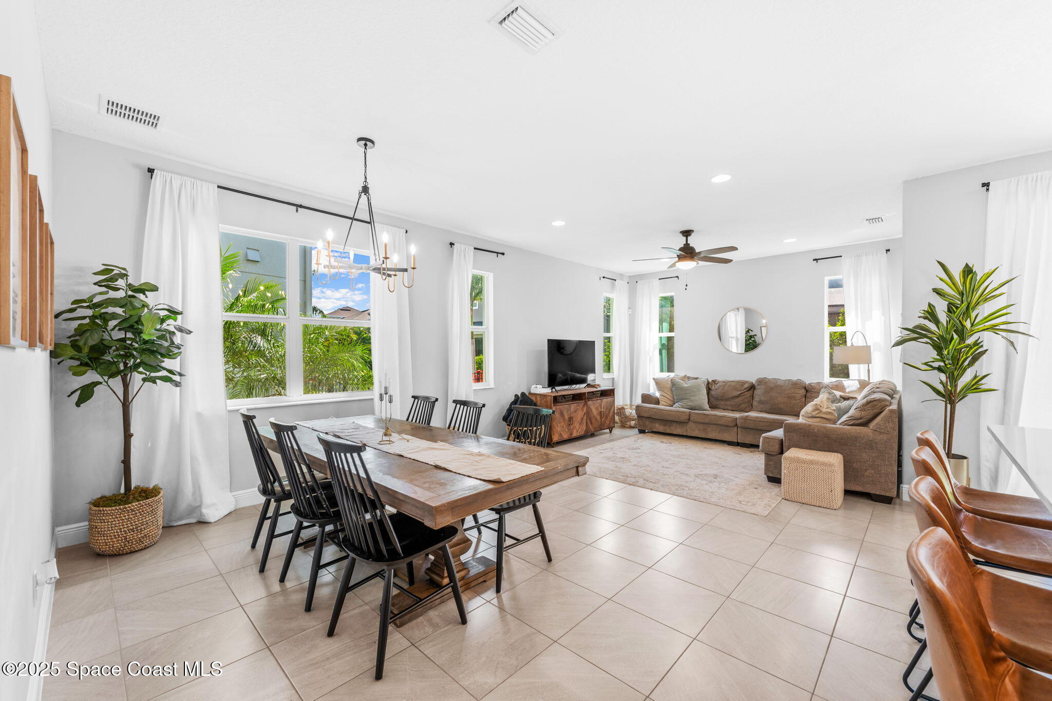 3089 Ribbon Grass Drive Melbourne, FL 32940 - Photo 11 of 57 a living room with furniture potted plant and a window