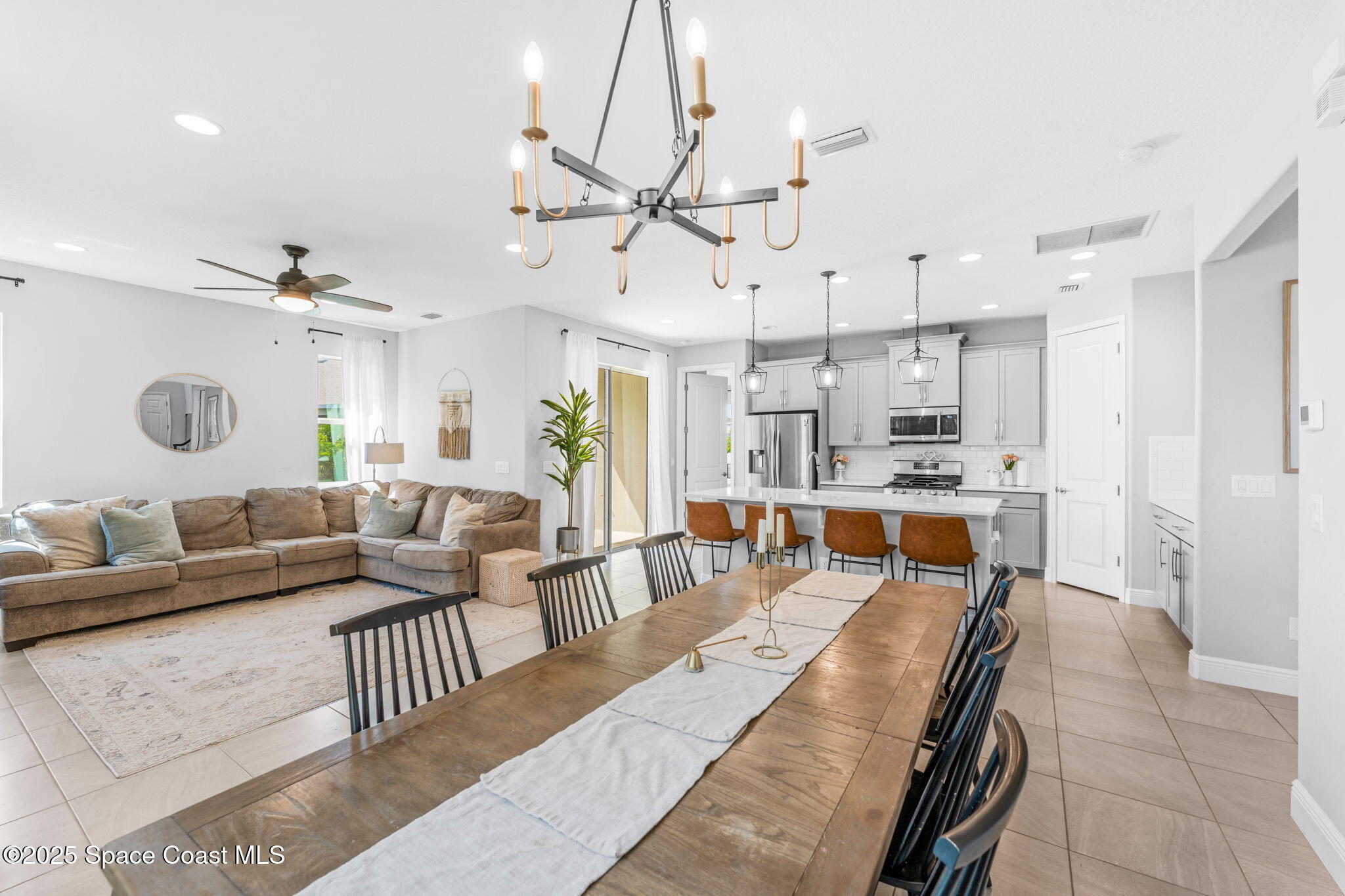 3089 Ribbon Grass Drive Melbourne, FL 32940 - Photo 14 of 57 a living room with lots of furniture and kitchen view