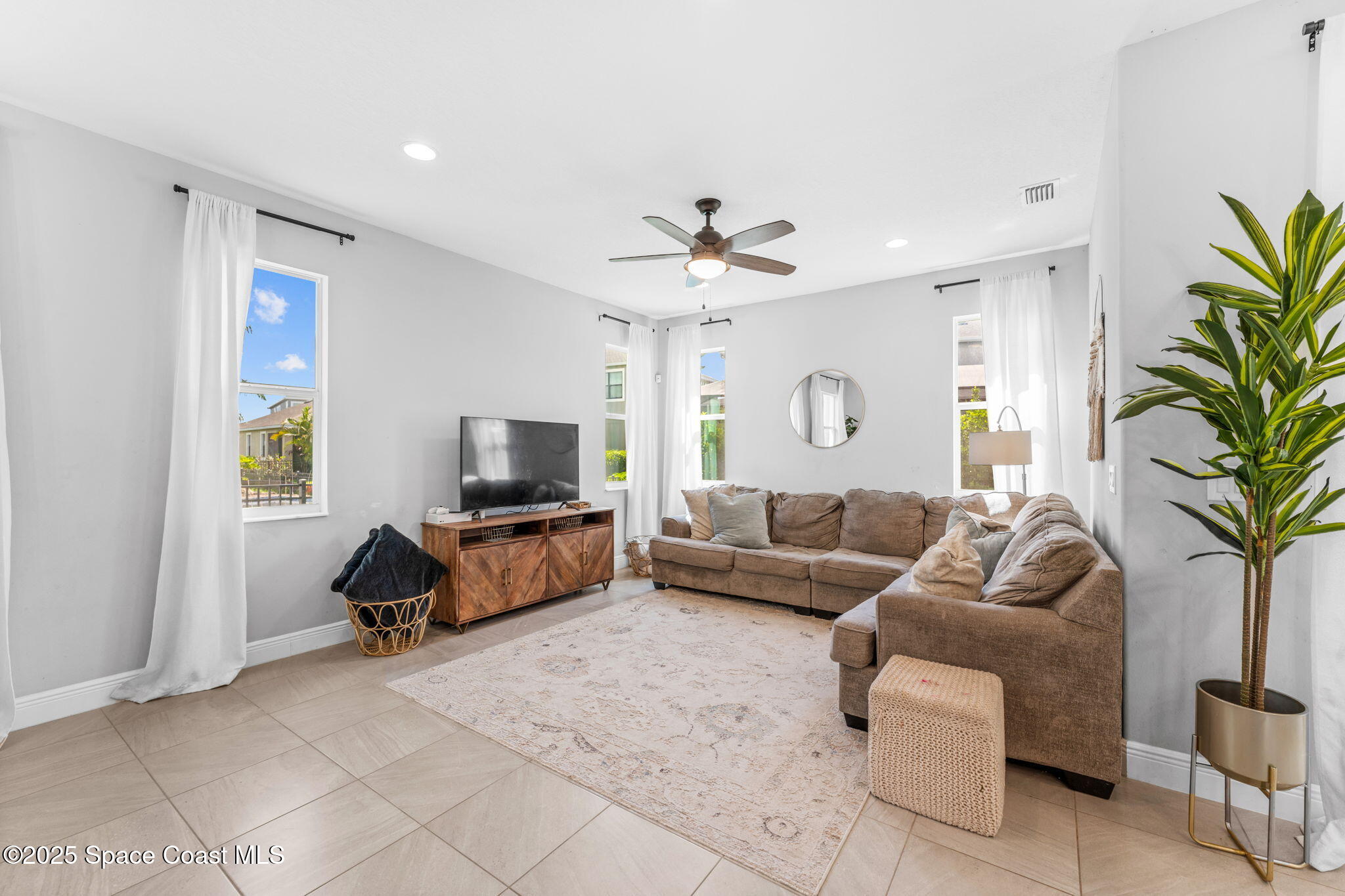 3089 Ribbon Grass Drive Melbourne, FL 32940 - Photo 15 of 57 a living room with furniture and a flat screen tv
