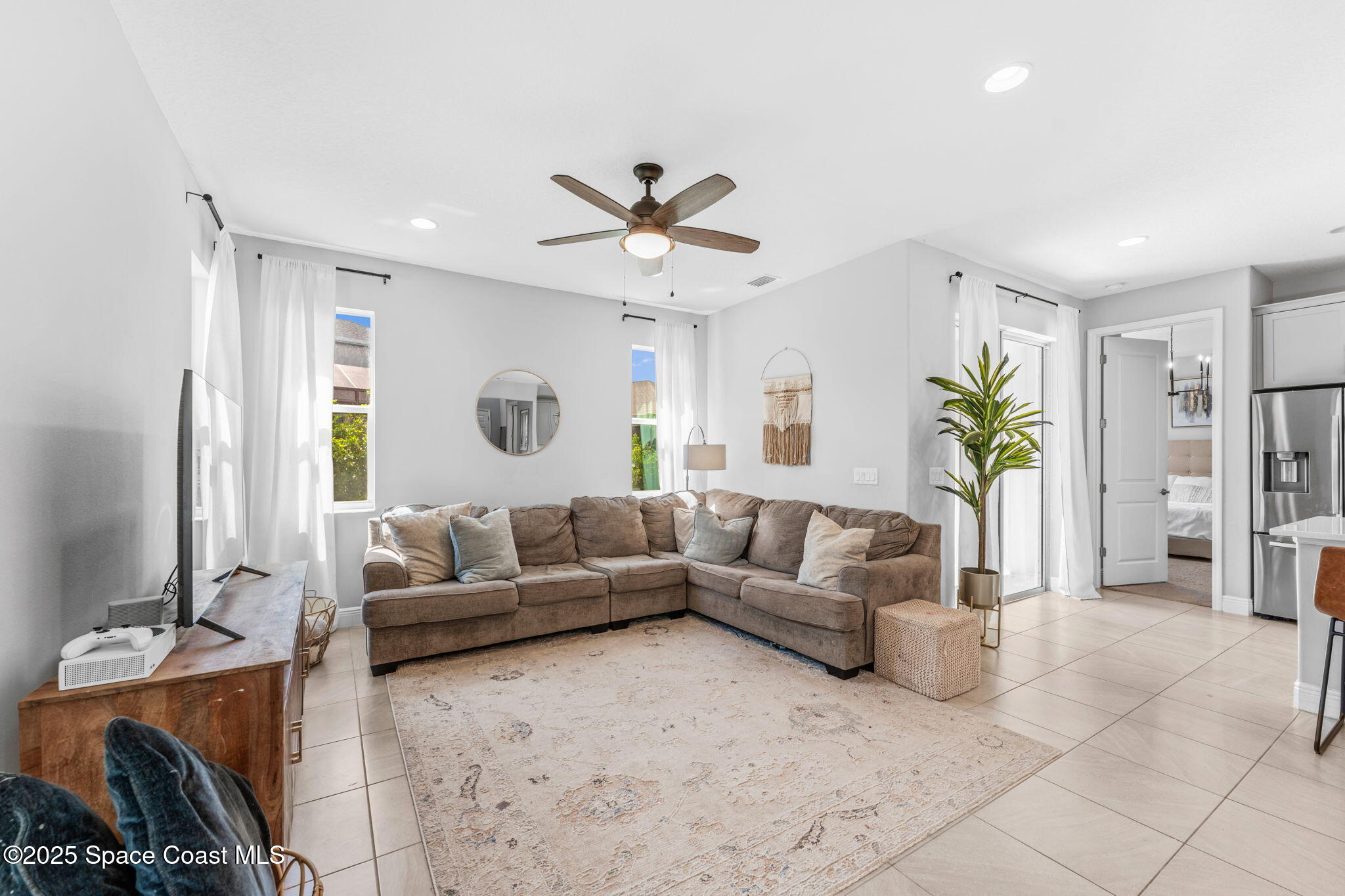 3089 Ribbon Grass Drive Melbourne, FL 32940 - Photo 17 of 57 a living room with furniture and a large window