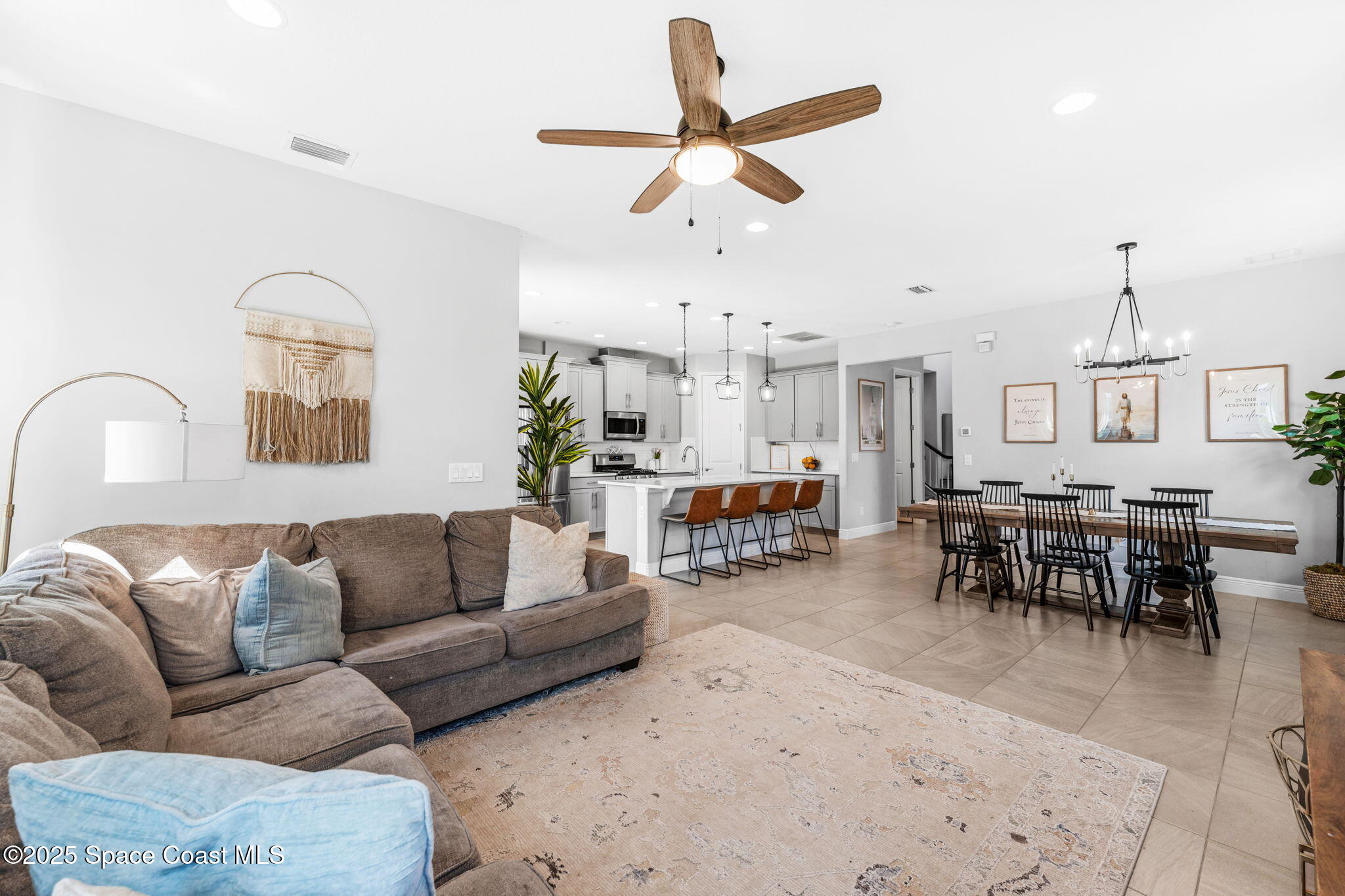 3089 Ribbon Grass Drive Melbourne, FL 32940 - Photo 18 of 57 a living room with furniture kitchen view and a wooden floor