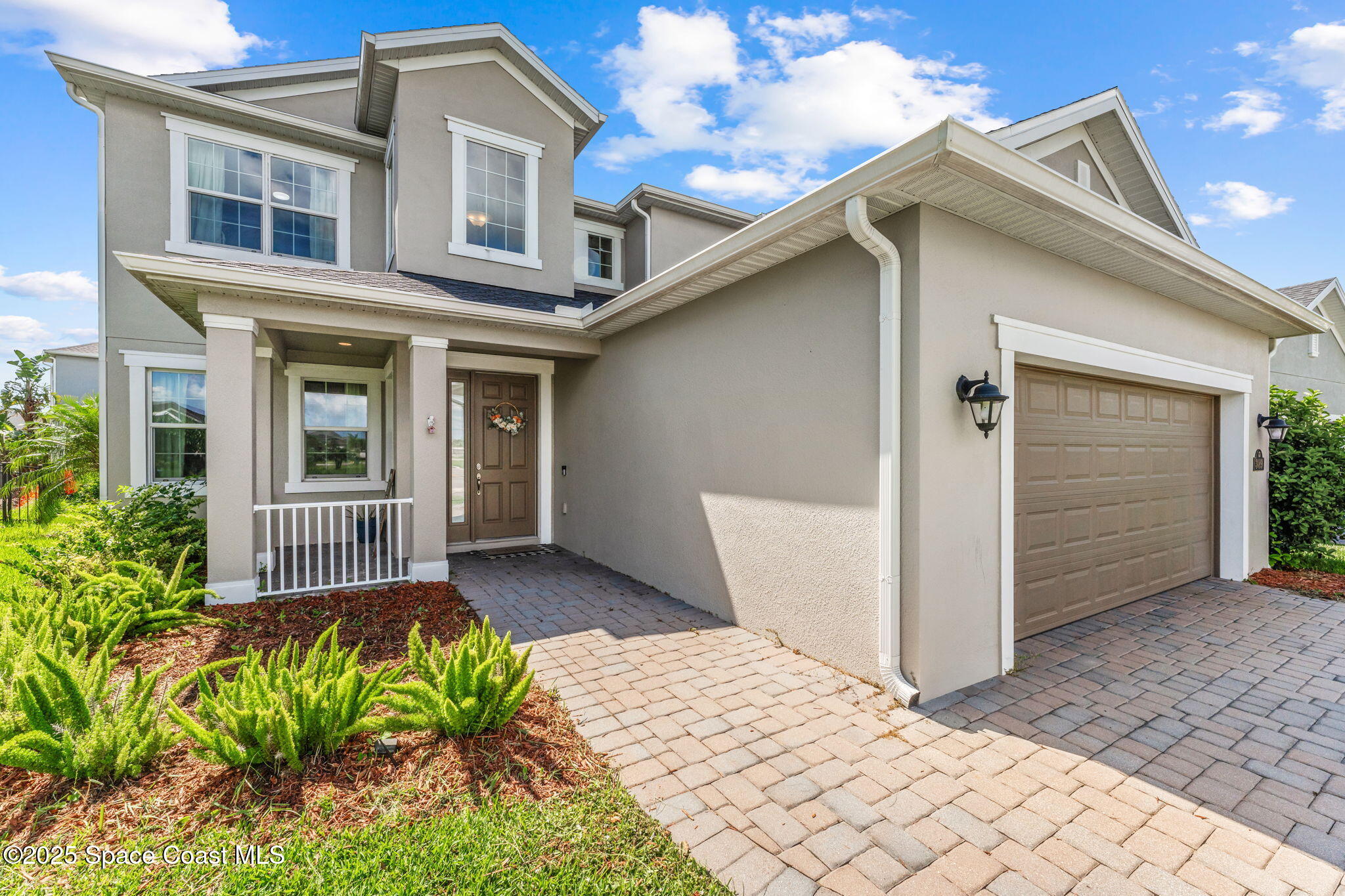3089 Ribbon Grass Drive Melbourne, FL 32940 - Photo 2 of 57 a front view of a house with a yard