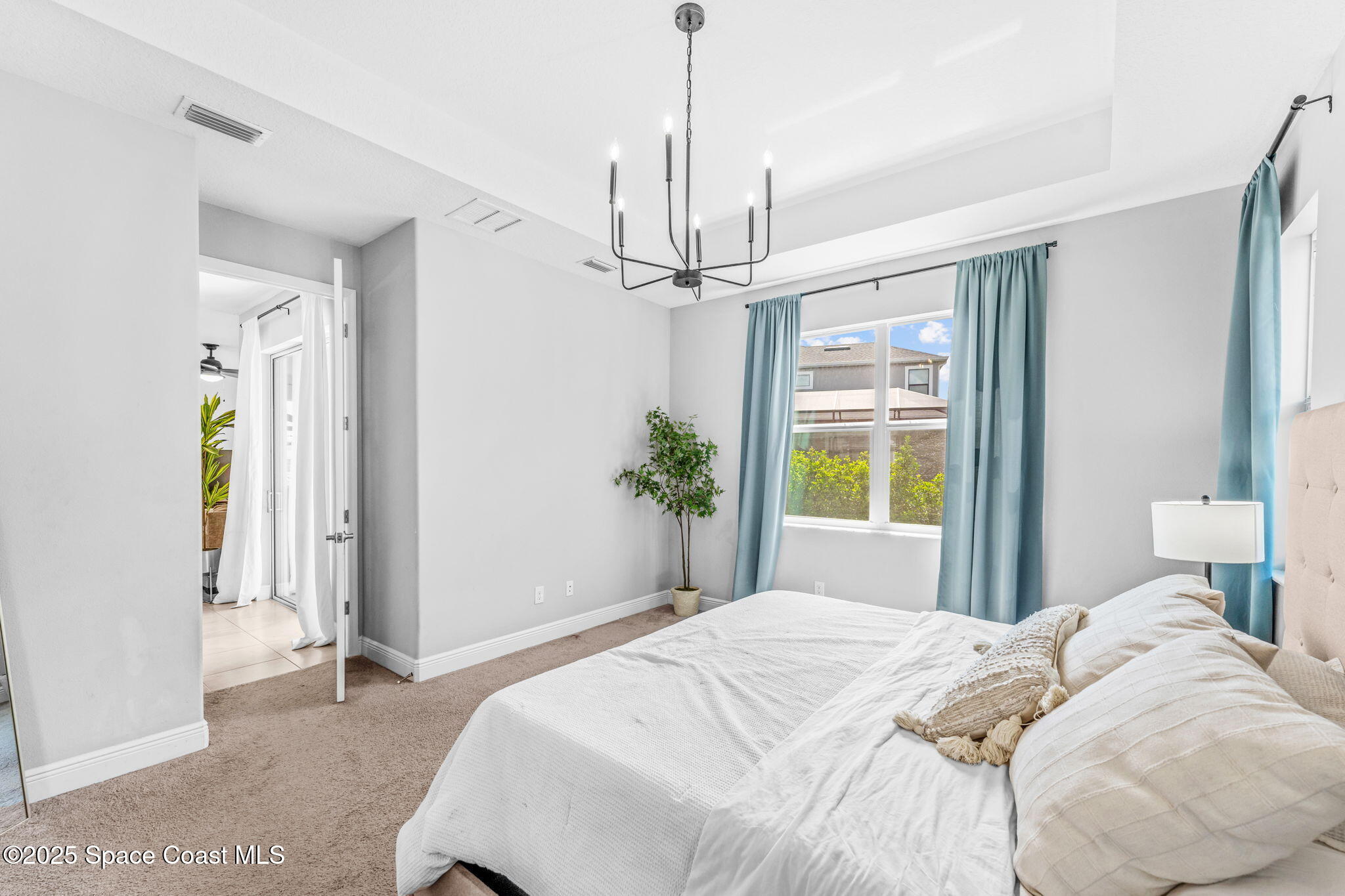 3089 Ribbon Grass Drive Melbourne, FL 32940 - Photo 20 of 57 a bedroom with a bed and a window