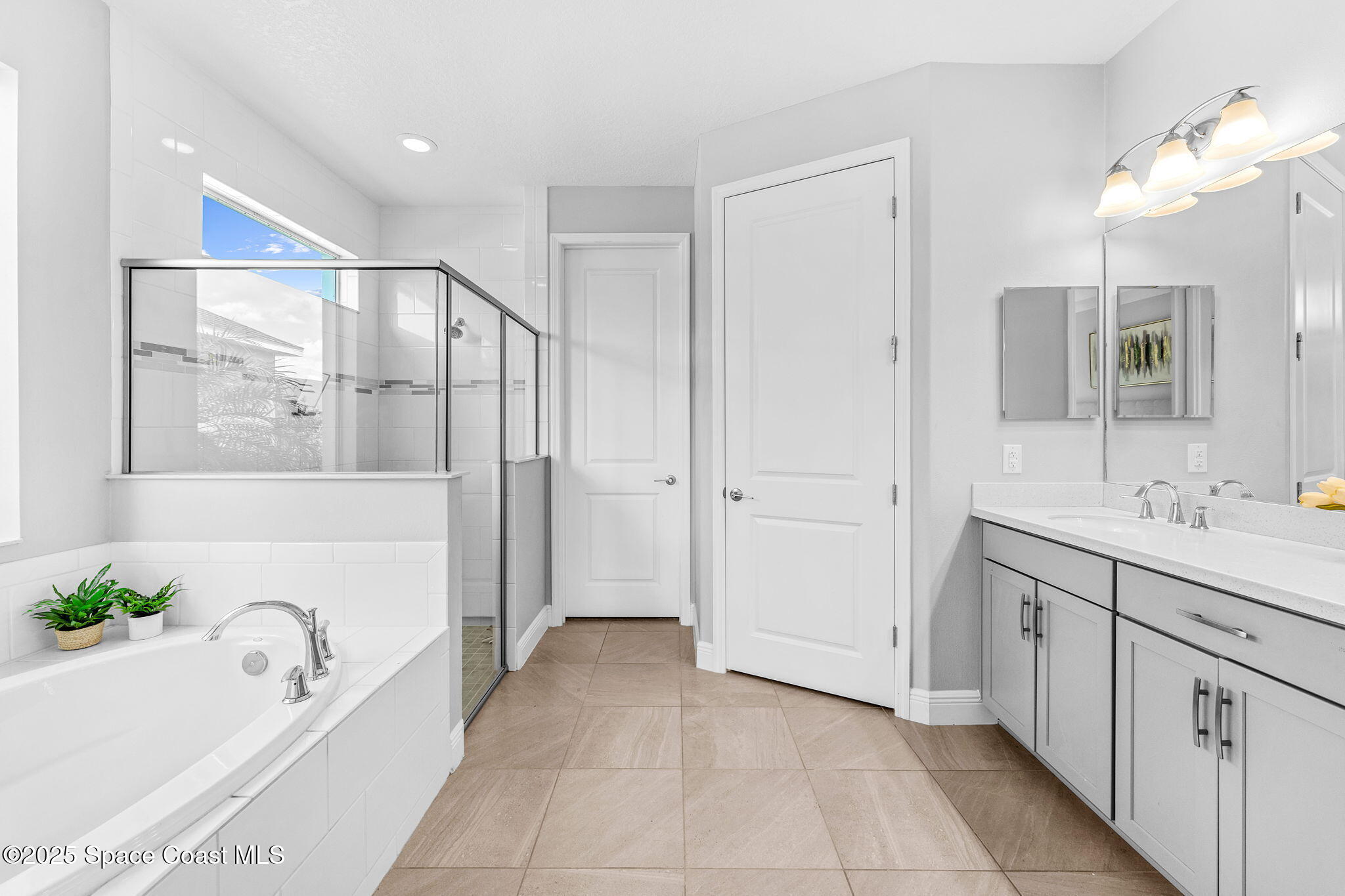 3089 Ribbon Grass Drive Melbourne, FL 32940 - Photo 21 of 57 a spacious bathroom with a tub sink and mirror