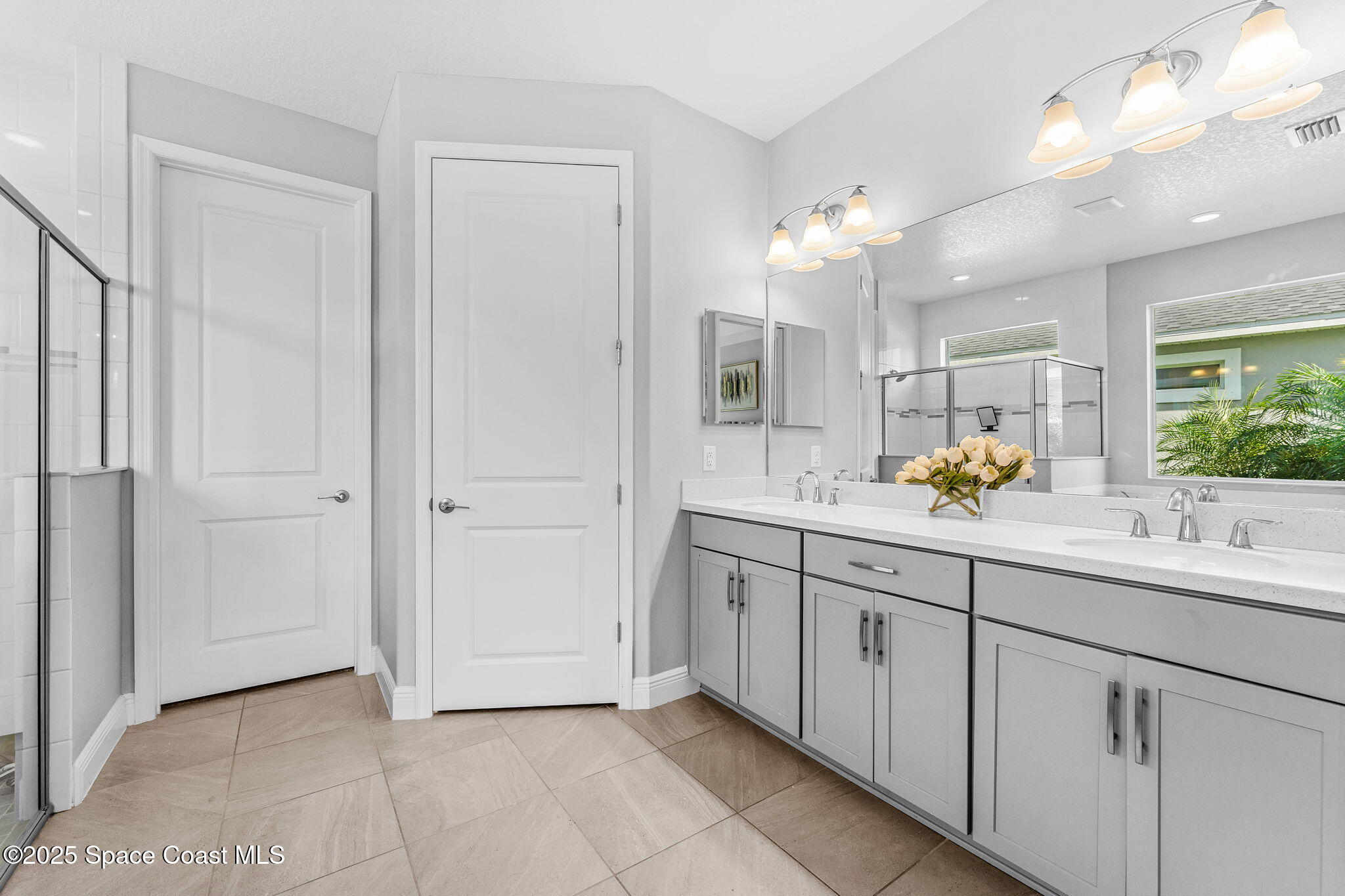 3089 Ribbon Grass Drive Melbourne, FL 32940 - Photo 22 of 57 a spacious bathroom with a double vanity sink mirror and next to a window