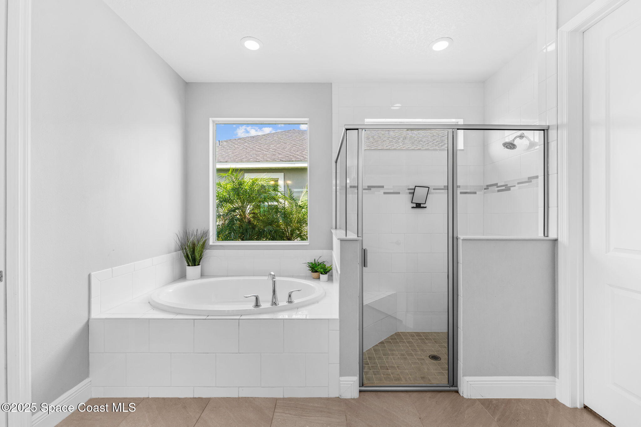 3089 Ribbon Grass Drive Melbourne, FL 32940 - Photo 23 of 57 a bathroom with a bathtub and a shower