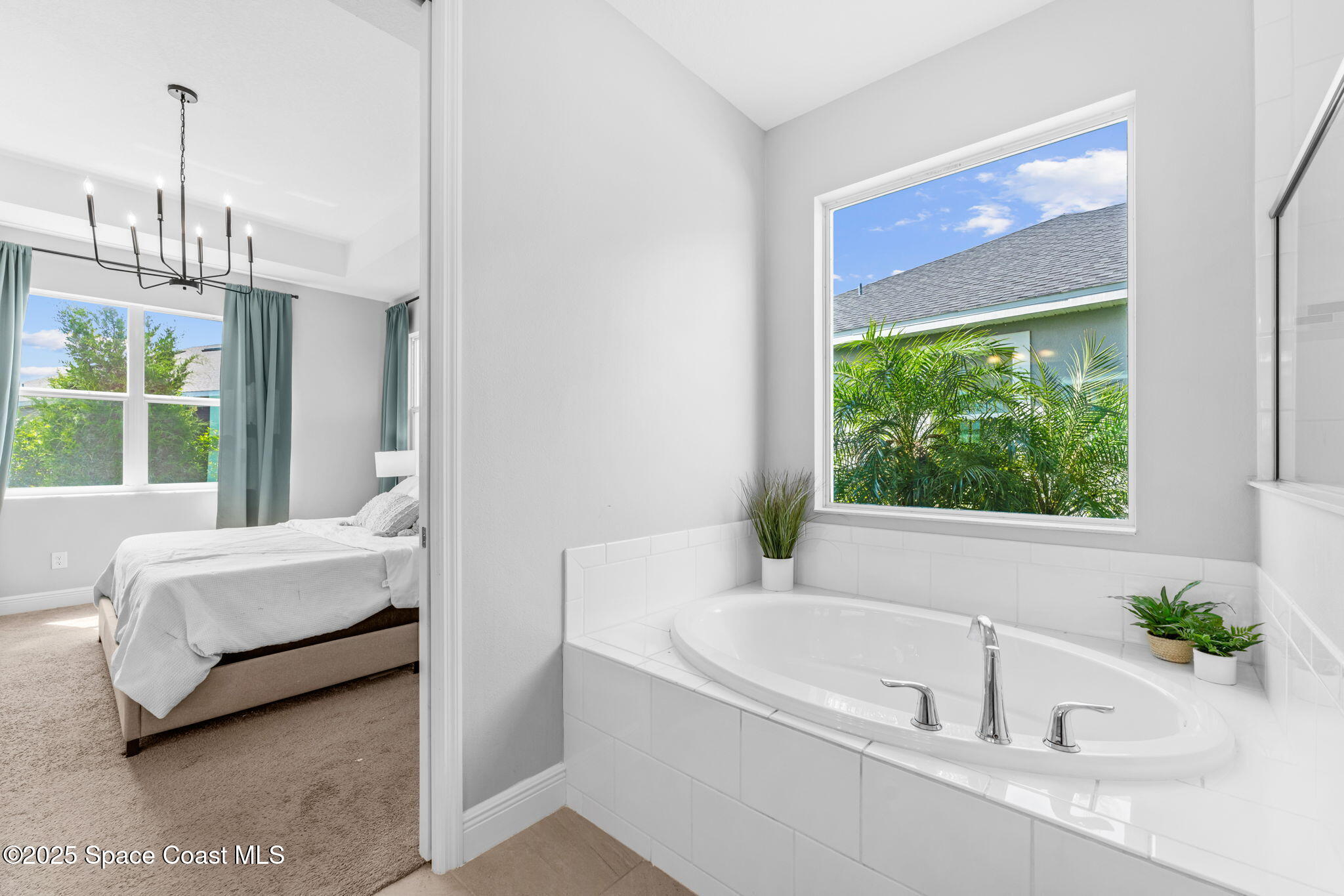 3089 Ribbon Grass Drive Melbourne, FL 32940 - Photo 24 of 57 a bathroom with a tub sink and window