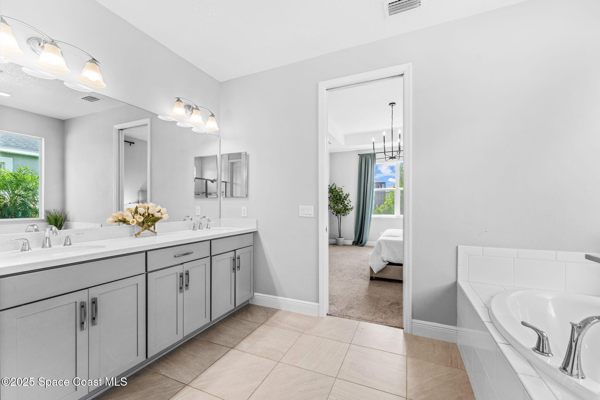 3089 Ribbon Grass Drive Melbourne, FL 32940 - Photo 25 of 57 a spacious bathroom with a tub sink and mirror