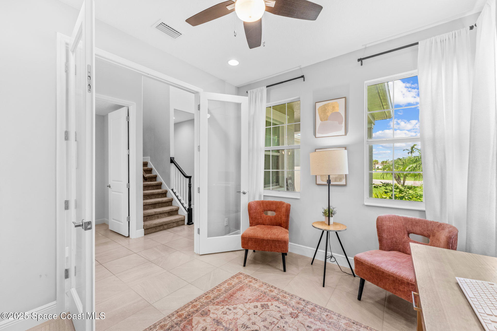 3089 Ribbon Grass Drive Melbourne, FL 32940 - Photo 28 of 57 a living room with furniture and a large window
