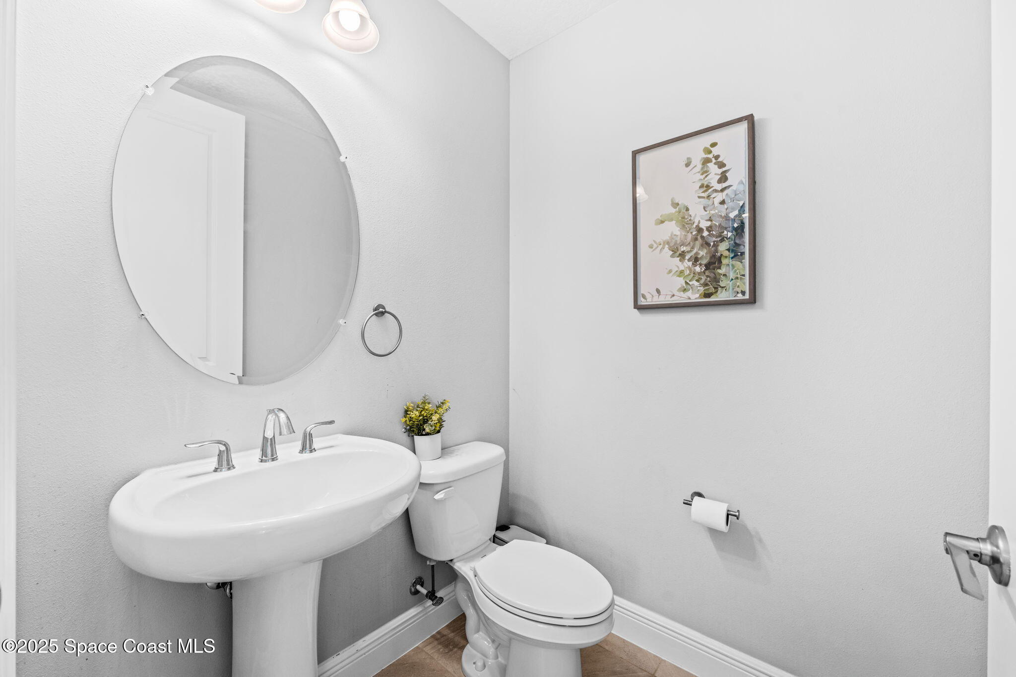 3089 Ribbon Grass Drive Melbourne, FL 32940 - Photo 29 of 57 a bathroom with a toilet a sink and mirror