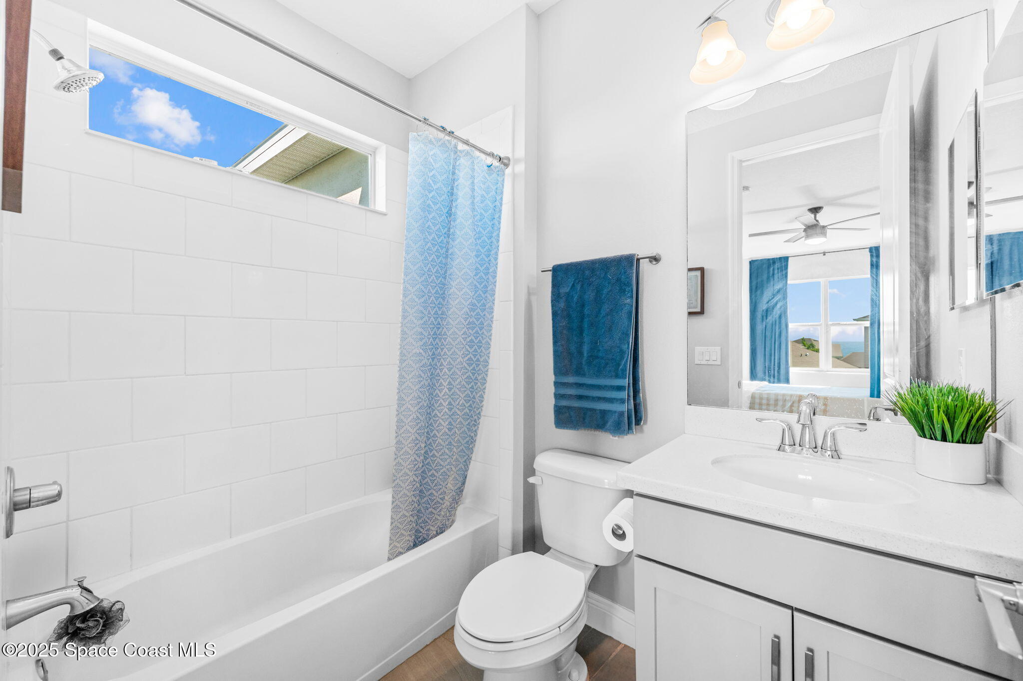 3089 Ribbon Grass Drive Melbourne, FL 32940 - Photo 36 of 57 a bathroom with a sink a toilet a mirror a vanity and shower