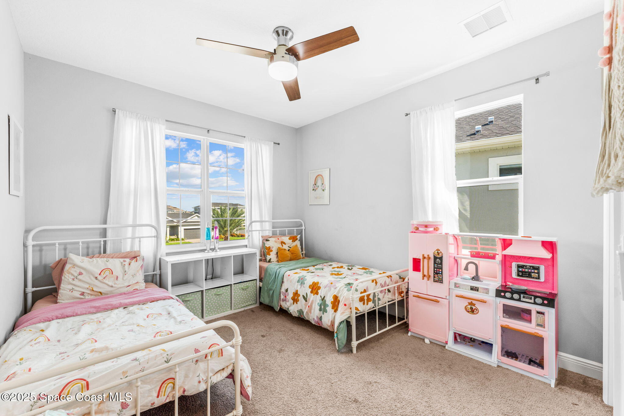 3089 Ribbon Grass Drive Melbourne, FL 32940 - Photo 37 of 57 a bedroom with a bed a dresser and a window