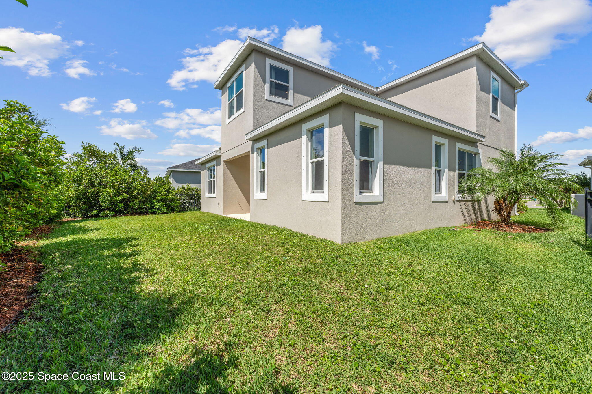 3089 Ribbon Grass Drive Melbourne, FL 32940 - Photo 39 of 57 a front view of a house with a yard and garage