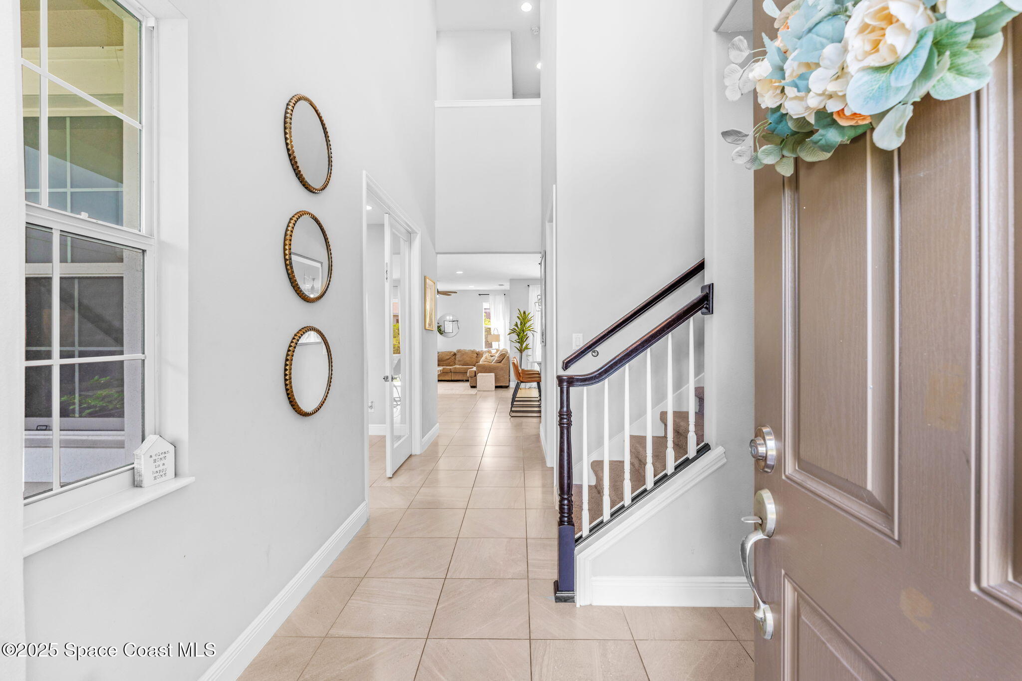 3089 Ribbon Grass Drive Melbourne, FL 32940 - Photo 3 of 57 a view of entryway with wooden floor and a chandelier