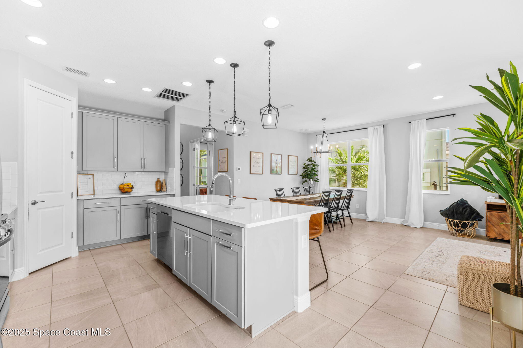 3089 Ribbon Grass Drive Melbourne, FL 32940 - Photo 8 of 57 a kitchen with a sink and counter top space