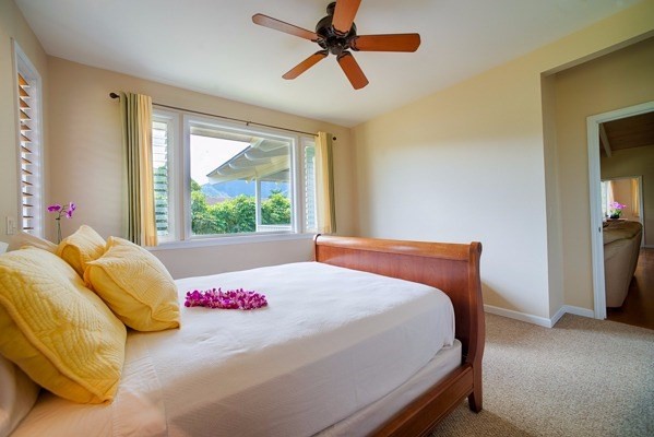 4451 Mahimahi Road Hanalei, HI 96714 - Photo 11 of 25 a bedroom with a bed and a window