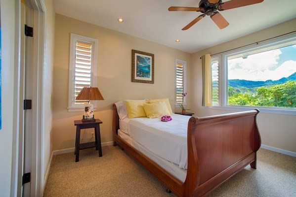 4451 Mahimahi Road Hanalei, HI 96714 - Photo 12 of 25 a bedroom with a bed and a table