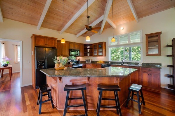 4451 Mahimahi Road Hanalei, HI 96714 - Photo 4 of 25 a dining room with stainless steel appliances granite countertop a table chairs and a wooden floor