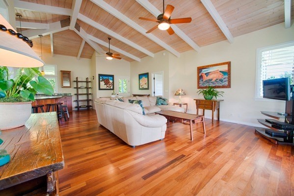 4451 Mahimahi Road Hanalei, HI 96714 - Photo 7 of 25 a living room with furniture a wooden floor and a flat screen tv