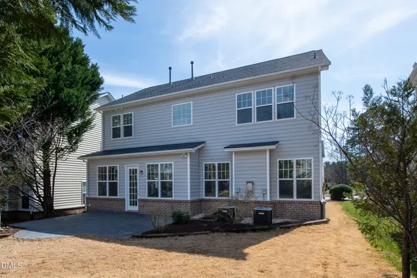 a front view of a house with a yard in front of it