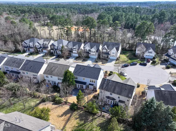 an aerial view of a house with a yard and lake view