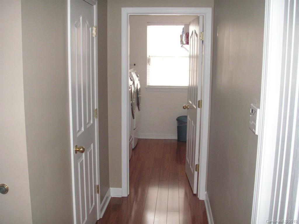 312 Altovista Court Fort Mill, SC 29708 - Photo 8 of 24 a view of a hallway with wooden floor and a cabinet