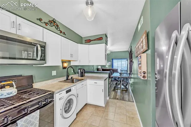 a kitchen with a sink a stove and cabinets