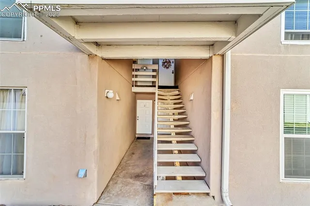 a view of entryway with stairs and wooden floor