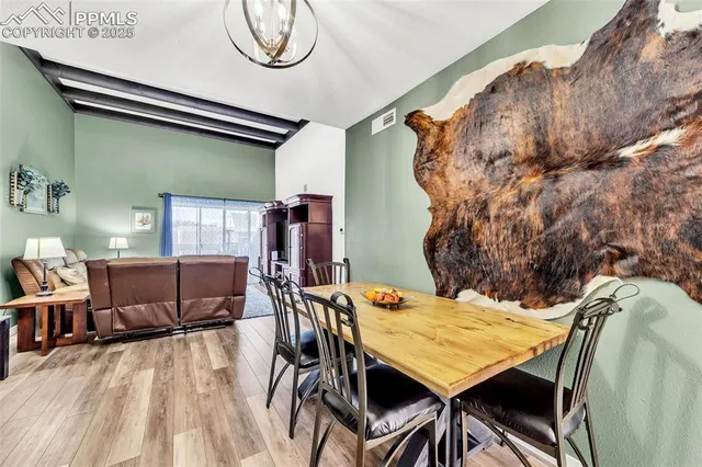 a view of a dining room with furniture and a table