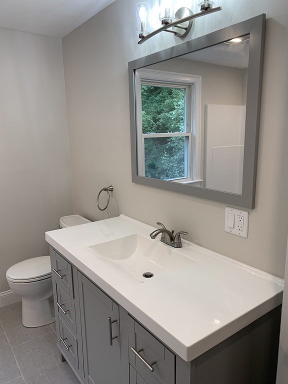 71 Narrows Road Freetown, MA 02702 - Photo 17 of 24 a bathroom with a sink a toilet and a window