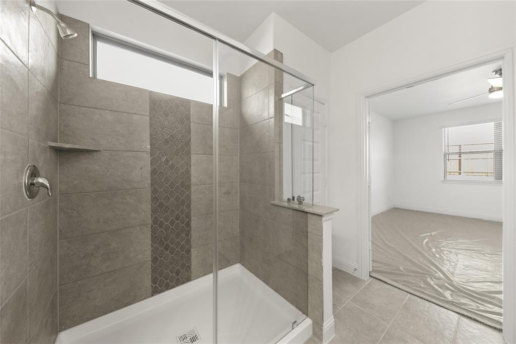 322 Boston Drive Princeton, TX 75407 - Photo 14 of 18 a bathroom with a bathtub and a shower