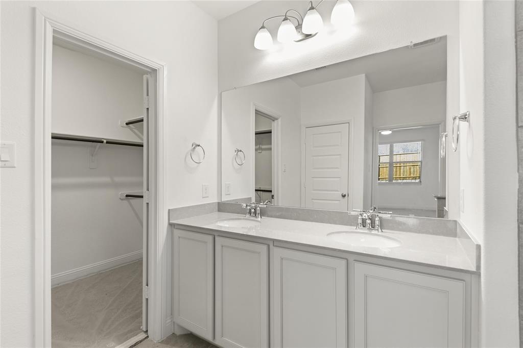 322 Boston Drive Princeton, TX 75407 - Photo 15 of 18 a bathroom with 2 sink and a mirror