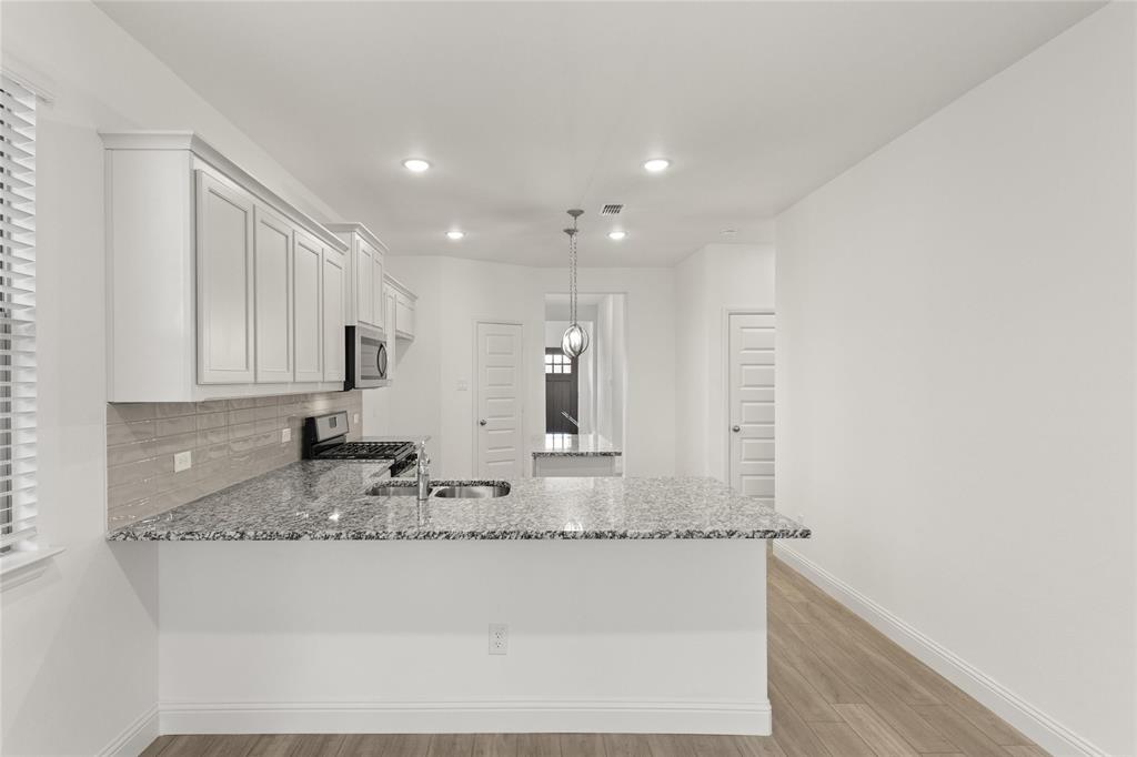 322 Boston Drive Princeton, TX 75407 - Photo 5 of 18 a view of kitchen with granite countertop cabinets