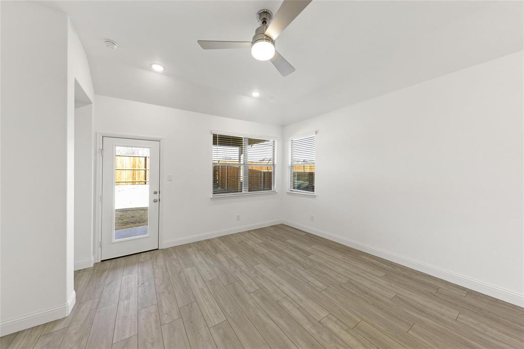 322 Boston Drive Princeton, TX 75407 - Photo 9 of 18 wooden floor in an empty room with a window