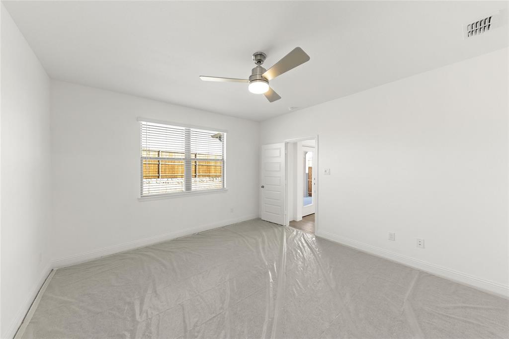322 Boston Drive Princeton, TX 75407 - Photo 10 of 18 an empty room with a window and ceiling fan