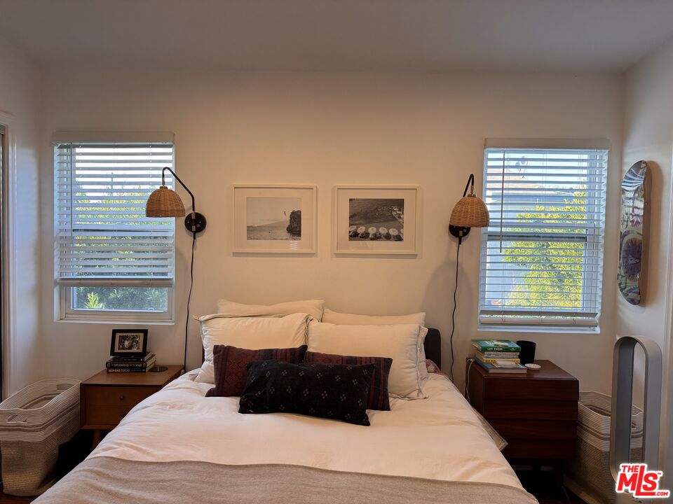 2639 6th Street Santa Monica, CA 90405 - Photo 10 of 22 a bedroom with a bed lamp and a large window