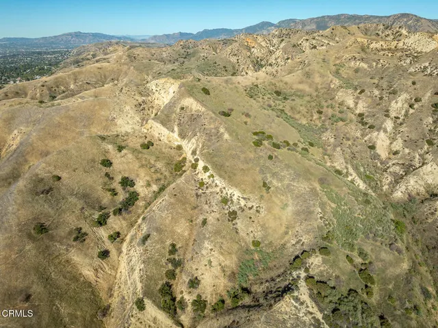 a view of a large mountain with mountains in the background