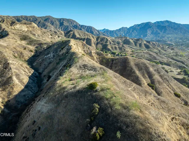 a view of a large mountain with mountains in the background