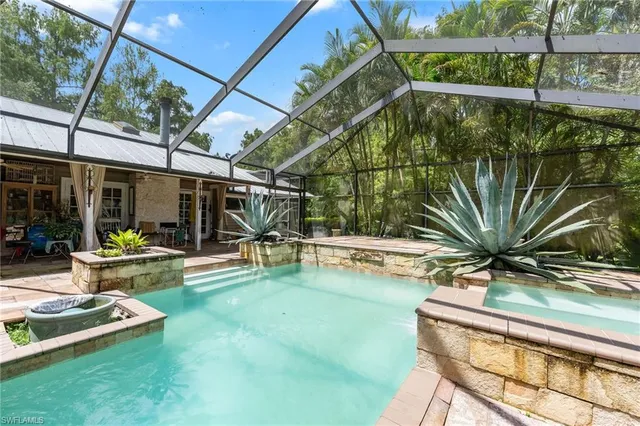 a view of a backyard with swimming pool