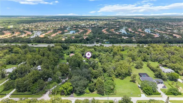 an aerial view of residential building with outdoor space and trees