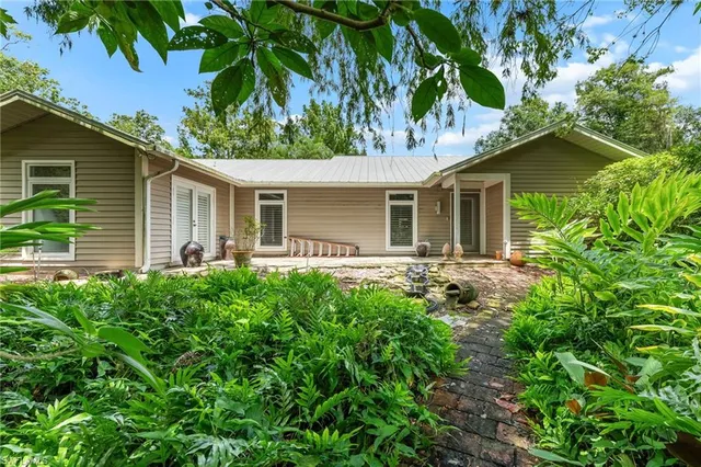 a front view of house with yard and green space