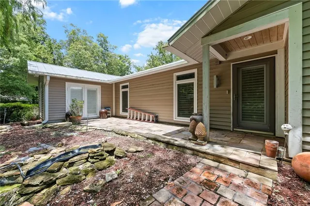 a backyard of a house with yard and outdoor seating