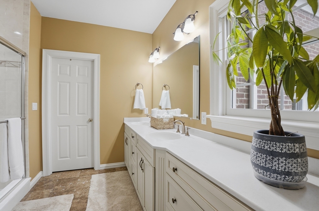 531 Salisbury Street Worcester, MA 01609 - Photo 19 of 42 a bathroom with a sink a mirror and a shower