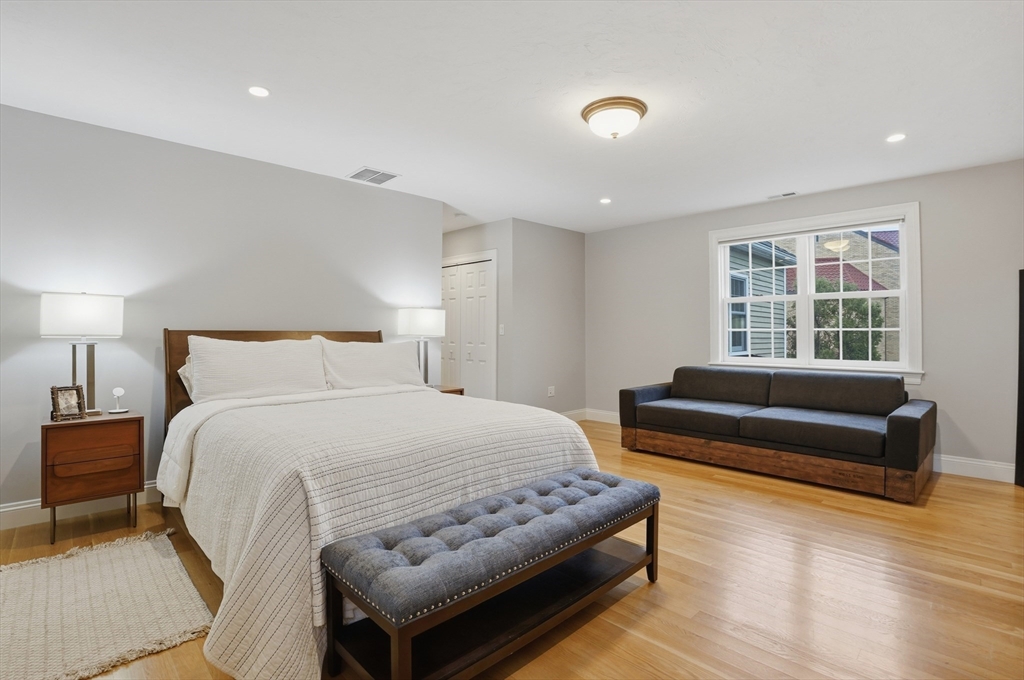 531 Salisbury Street Worcester, MA 01609 - Photo 25 of 42 a bedroom with a bed and wooden floor